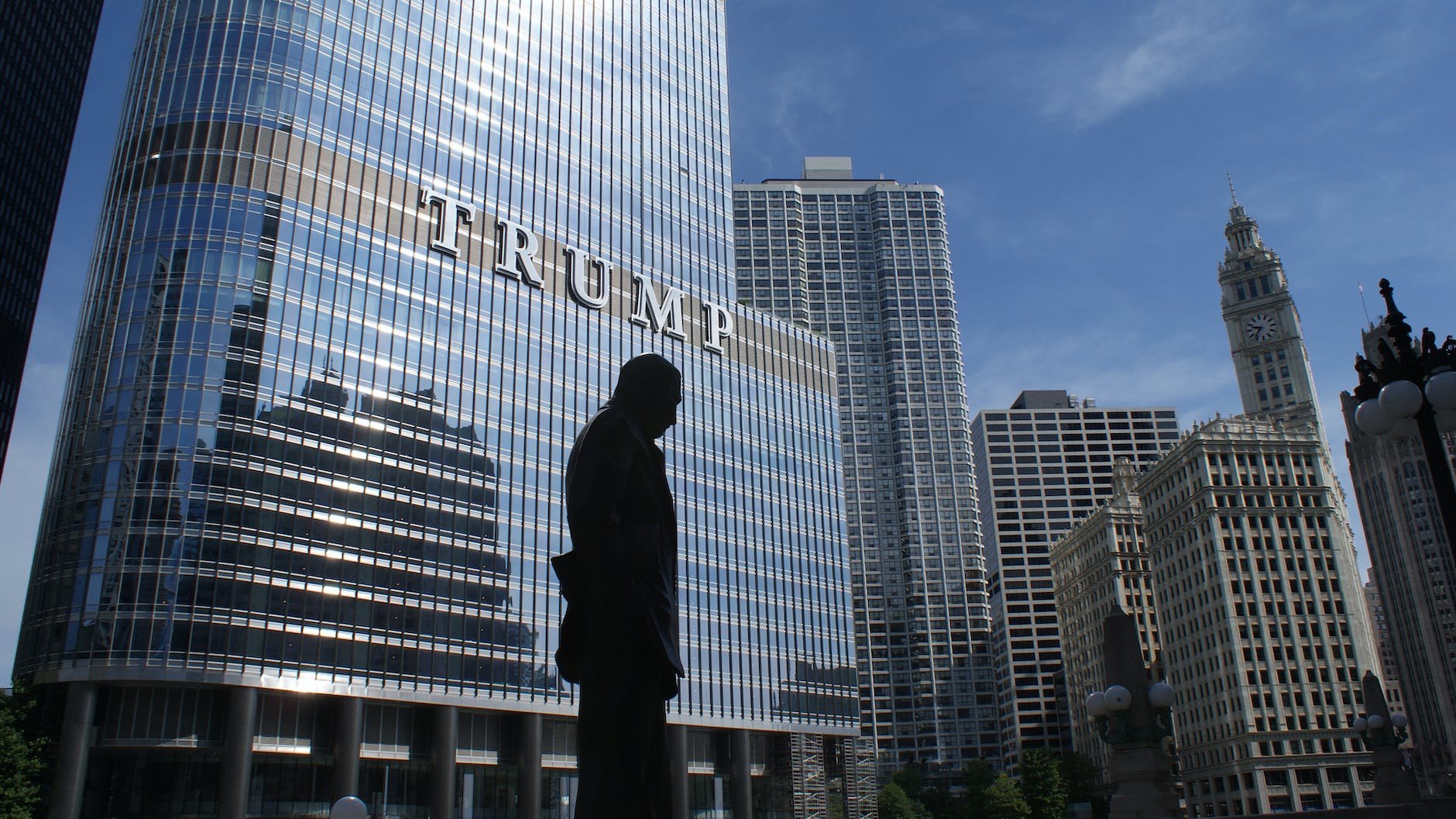 Tunnel vision on the presidential aspect - silhouette of statue near trump building at daytime