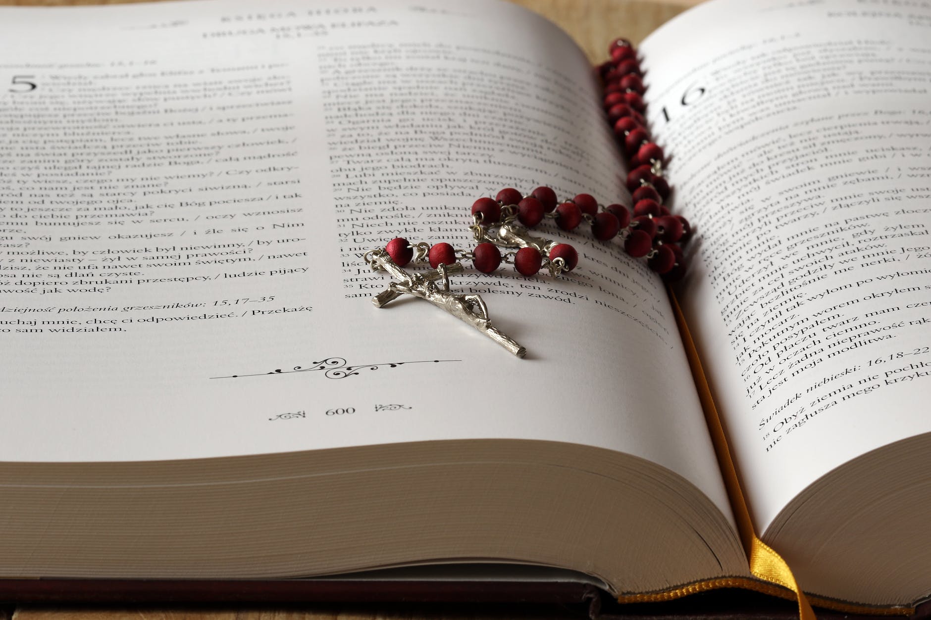 REeigion: What is it good for? rosary on top of opened bible book