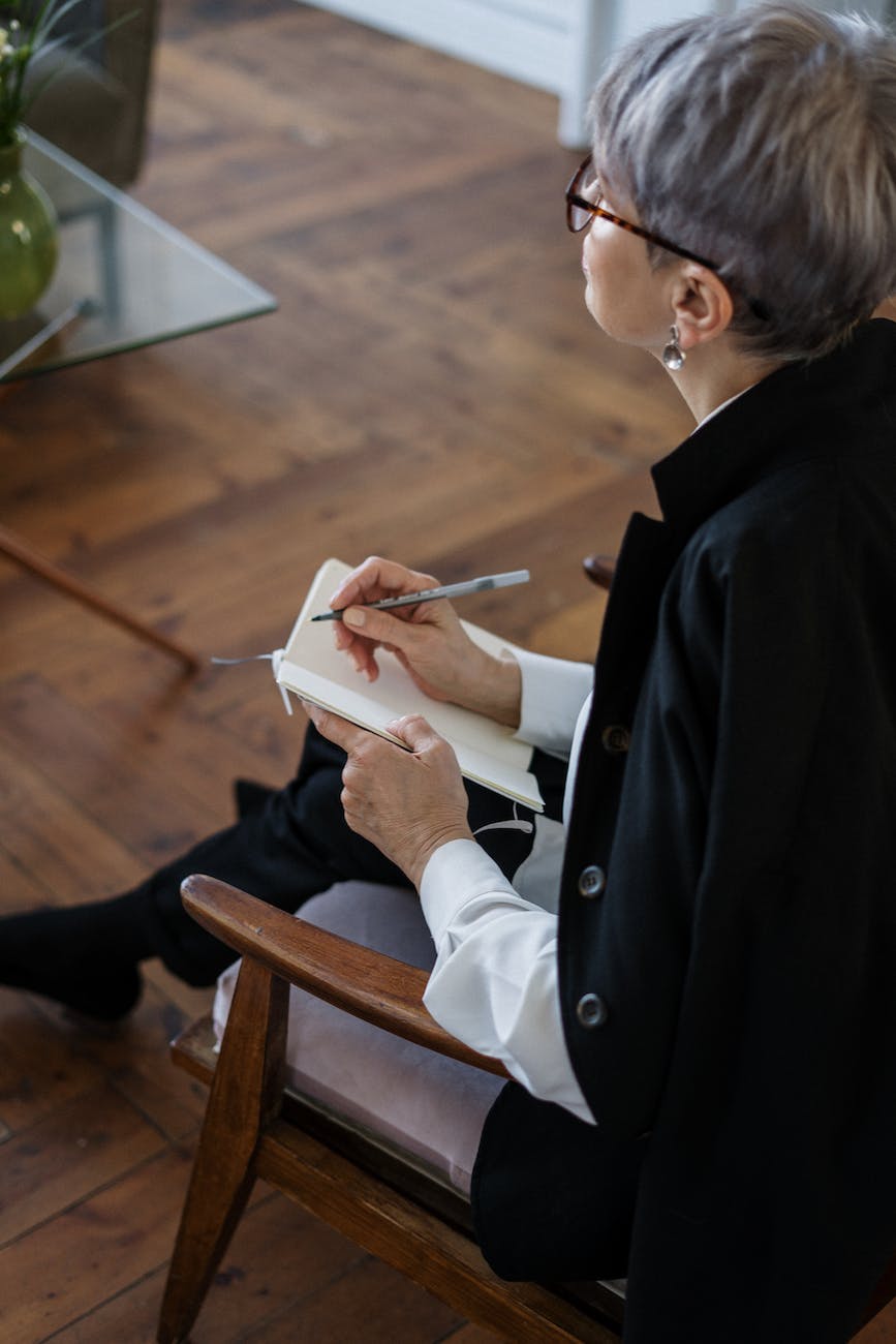 Voice dialogue - woman in black blazer holding white tablet computer