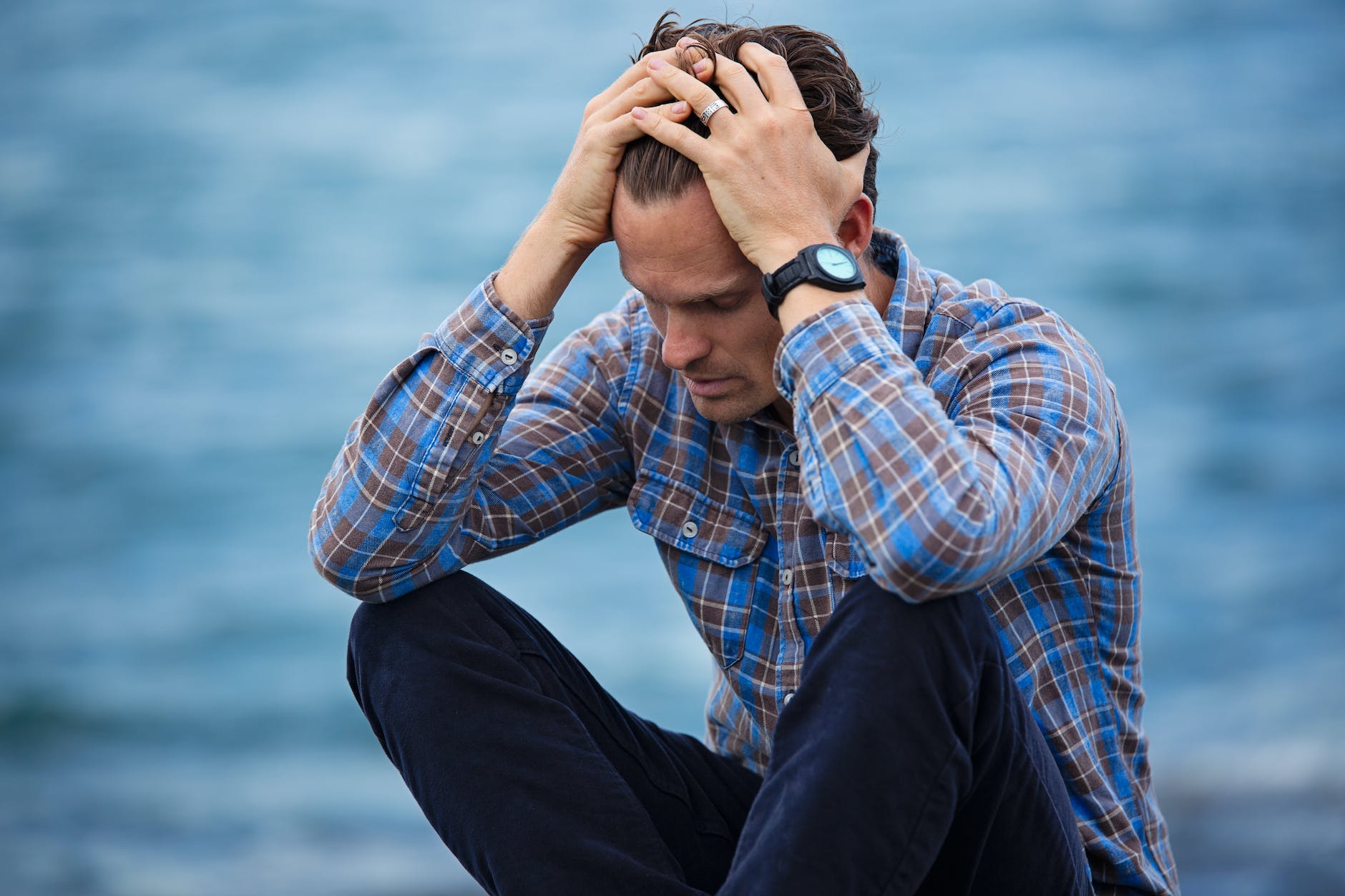 Is it time for price controls? man in blue and brown plaid dress shirt touching his hair