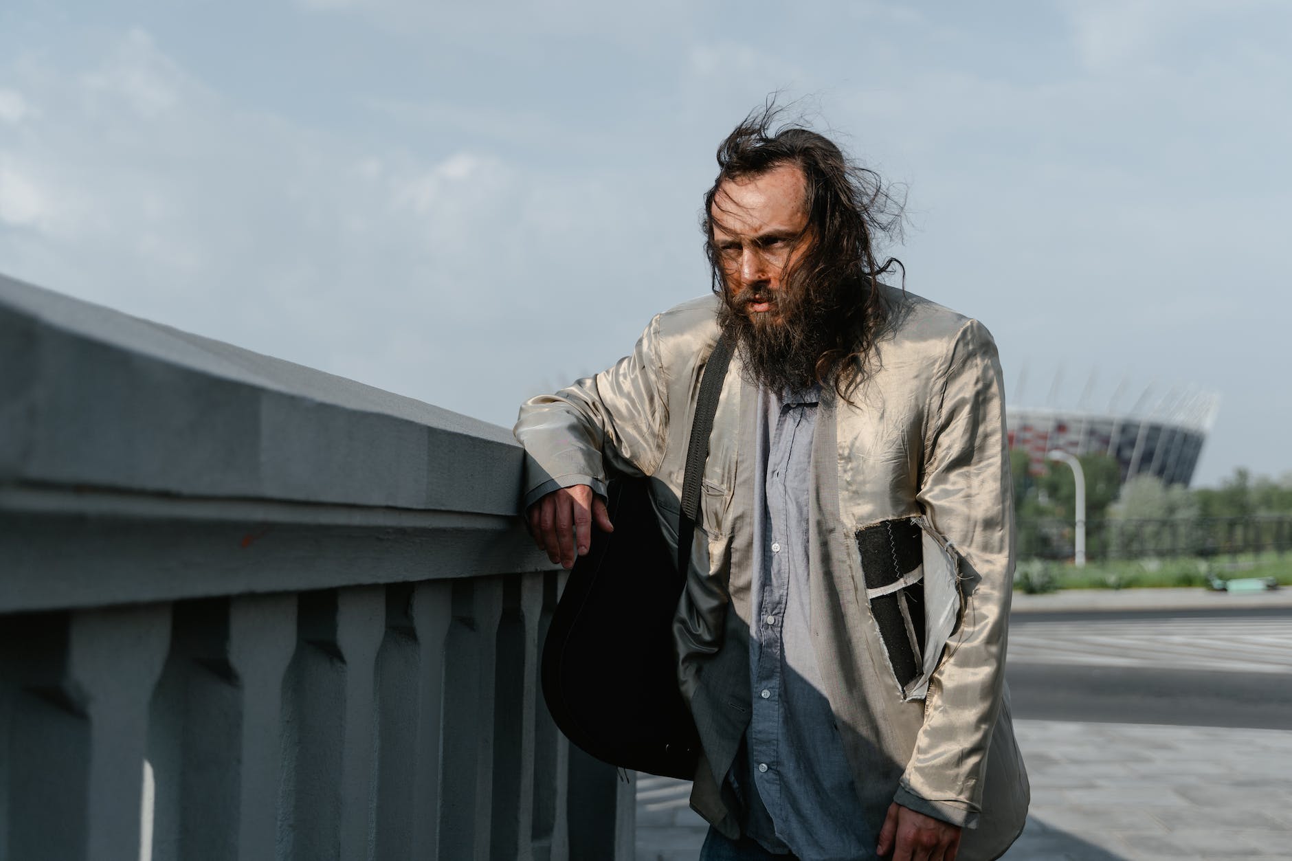 a bearded man standing on the street