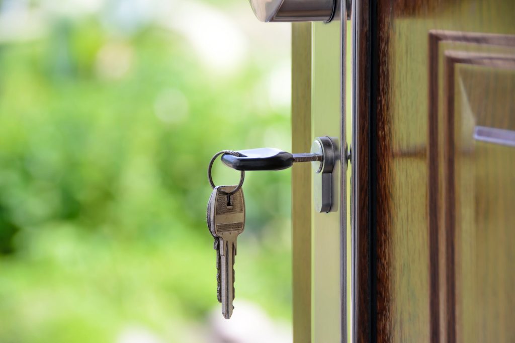 black handled key on key hole - social housing