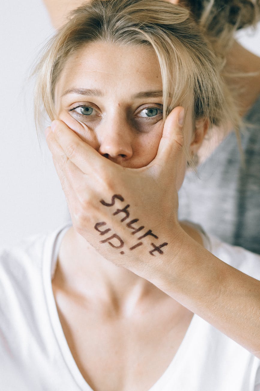 close upphoto of woman s face held by a hand