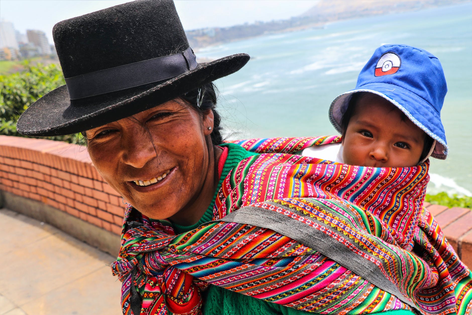 woman carrying her baby in a carrying cloth