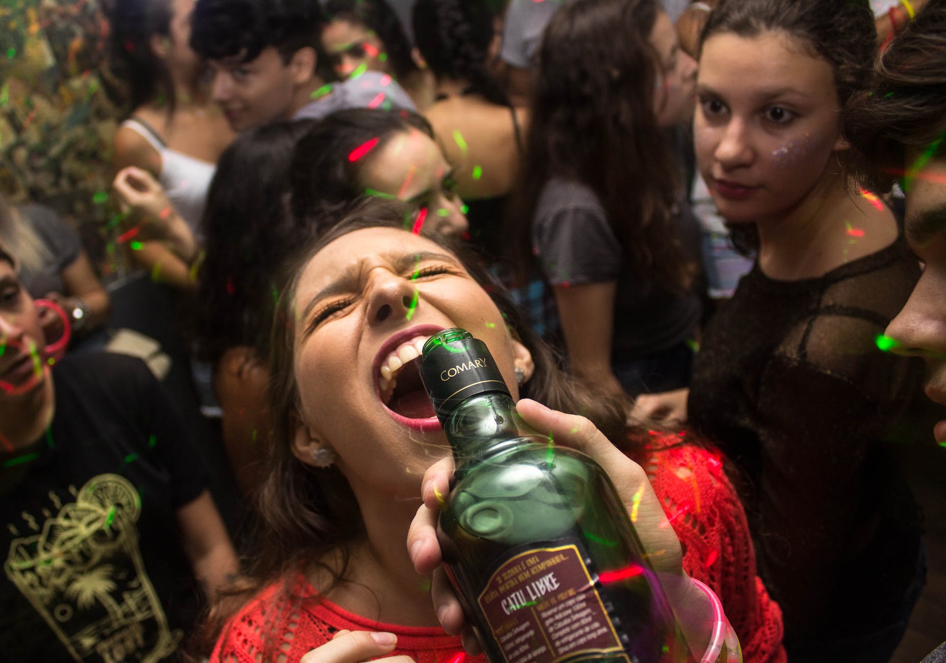 woman wearing red shirt drinking