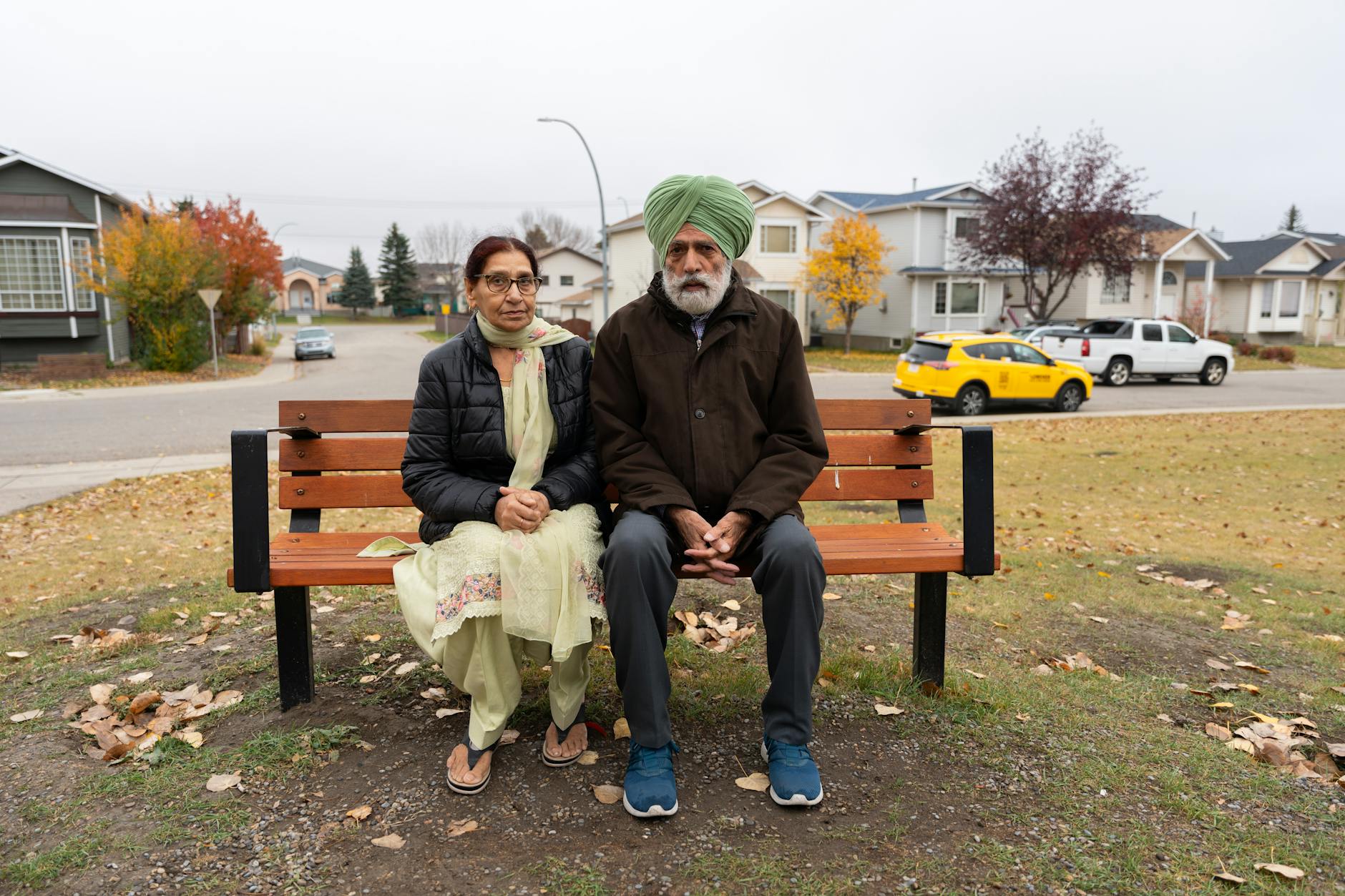 couple sitting on bench in urban suburb