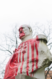 man in red and white stripe shirt statue